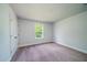 Bedroom with carpeted floors, a double door closet, a window, and a light gray painted wall at 154 Royal Cainhoy Way, Huger, SC 29450