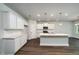 Bright kitchen features an island, stainless steel appliances, recessed lighting, and dark hardwood floors at 154 Royal Cainhoy Way, Huger, SC 29450