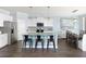 Modern kitchen with stainless steel appliances, island seating, and an adjacent dining area at 154 Royal Cainhoy Way, Huger, SC 29450