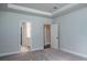 Spacious primary bedroom showcasing tray ceilings and ensuite bathroom entrances, perfect for relaxation at 154 Royal Cainhoy Way, Huger, SC 29450