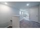 Carpeted second floor hallway with views of rooms through doorways and a staircase leading to the first floor at 154 Royal Cainhoy Way, Huger, SC 29450