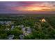 Breathtaking aerial view of a lush, green neighborhood with a stunning sunset sky at 1606 Stovall Ct, Johns Island, SC 29455