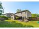 Spacious backyard features a patio with a fire pit, outdoor seating, and lush green grass, perfect for entertaining at 1606 Stovall Ct, Johns Island, SC 29455
