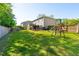 Large backyard featuring patio, playset, and lush lawn, perfect for outdoor activities and Gathering fun at 1606 Stovall Ct, Johns Island, SC 29455