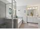 Bright bathroom featuring a glass enclosed shower, separate soaking tub, and double vanity at 1606 Stovall Ct, Johns Island, SC 29455