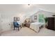 Attic bedroom with natural light and neutral colors, featuring a chair, plant, and dresser at 1606 Stovall Ct, Johns Island, SC 29455