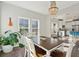 Bright dining area featuring a unique light fixture, and easy access to the kitchen and living spaces at 1606 Stovall Ct, Johns Island, SC 29455