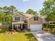 Charming two-story home with a well-manicured lawn, attached garage, and inviting front porch at 1606 Stovall Ct, Johns Island, SC 29455