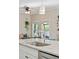 Close-up of kitchen island with granite countertop and a modern faucet with views into living area at 1606 Stovall Ct, Johns Island, SC 29455