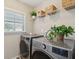 Functional laundry room featuring modern LG washer and dryer beneath a shelf with baskets at 1606 Stovall Ct, Johns Island, SC 29455