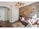 Inviting living area enhanced by wood paneling, creating a warm, stylish ambiance with a comfortable couch at 1606 Stovall Ct, Johns Island, SC 29455