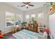 Spacious playroom with a vibrant rug, multiple windows, and comfortable seating perfect for playtime at 1606 Stovall Ct, Johns Island, SC 29455