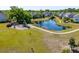 Aerial view of community pond featuring a fountain, playground, and walking paths, creating a serene outdoor environment at 1606 Stovall Ct, Johns Island, SC 29455