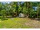 A backyard with a storage shed, carport, and plenty of greenery at 1621 Wannamaker Ave, Summerville, SC 29485