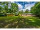 A large grassy backyard with mature trees and a storage shed at 1621 Wannamaker Ave, Summerville, SC 29485