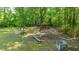 Expansive backyard featuring a shed with a hammock, fire pit area, and concrete construction blocks at 1621 Wannamaker Ave, Summerville, SC 29485