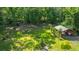 Lush backyard with detached structure amidst mature trees and greenery, enhancing privacy and outdoor enjoyment at 1621 Wannamaker Ave, Summerville, SC 29485
