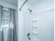 Clean bathroom features a tub and shower with modern fixtures and a window at 1621 Wannamaker Ave, Summerville, SC 29485