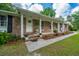 Charming front porch with brick facade, decorative columns, and inviting entrance, perfect for relaxing at 1621 Wannamaker Ave, Summerville, SC 29485