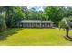 Charming brick home featuring a manicured lawn and inviting curb appeal with mature trees and a classic design at 1621 Wannamaker Ave, Summerville, SC 29485
