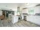 Modern kitchen with stainless steel appliances and island seamlessly connecting to the dining area at 1621 Wannamaker Ave, Summerville, SC 29485