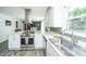 Modern kitchen with white cabinets, stainless steel appliances, and sleek countertops at 1621 Wannamaker Ave, Summerville, SC 29485