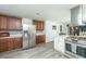 Spacious kitchen with stainless steel appliances, wooden cabinetry, and granite countertops at 1621 Wannamaker Ave, Summerville, SC 29485