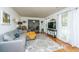Bright living room featuring hardwood floors, a comfortable sofa, and large windows offering ample natural light at 1621 Wannamaker Ave, Summerville, SC 29485