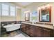 Elegant bathroom with a soaking tub, granite countertops, dual vanities, and updated fixtures at 1650 Long Grove Dr, Mount Pleasant, SC 29464