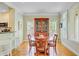 Dining room with wood floors, dining table, chairs, and china cabinet near kitchen at 1650 Long Grove Dr, Mount Pleasant, SC 29464