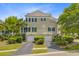 Rear exterior of the townhome featuring private two-car garages and a well-maintained lawn and landscaping at 1650 Long Grove Dr, Mount Pleasant, SC 29464