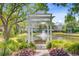 Relaxing pond view from a gazebo with a tranquil fountain, a sitting bench, and lovely landscaping at 1650 Long Grove Dr, Mount Pleasant, SC 29464