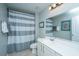 Bathroom with single sink, a gray and white striped shower curtain and tiled flooring at 1823 Chauncys Ct, Mount Pleasant, SC 29466