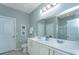 Bright bathroom features a double sink vanity, framed mirror, and shower with glass enclosure at 1823 Chauncys Ct, Mount Pleasant, SC 29466