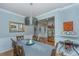 Dining area with decorative lighting, wood table, and view into another room with display cabinet at 1823 Chauncys Ct, Mount Pleasant, SC 29466