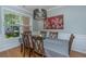 A dining area features a table, seating for six, with a view of green foliage through the window at 1823 Chauncys Ct, Mount Pleasant, SC 29466