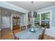 A dining area features hardwood floors, white chair-rail, table for six, and a view of foliage at 1823 Chauncys Ct, Mount Pleasant, SC 29466
