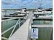 View of the boat dock with several yachts under a cloudy blue sky at 1880 Andell Bluff Blvd # F-3, Seabrook Island, SC 29455