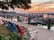 Relaxing marina view with multiple colorful chairs along the wooden dock and many boats docked, great for unwinding at 1880 Andell Bluff Blvd # F-3, Seabrook Island, SC 29455