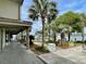 Charming covered patio with tropical plants overlooks a scenic marina with multiple boats docked nearby at 1880 Andell Bluff Blvd # F-3, Seabrook Island, SC 29455