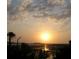 Picturesque sunset scene overlooking a marsh with silhouetted trees, water, and sky creating a serene atmosphere at 1880 Andell Bluff Blvd # F-3, Seabrook Island, SC 29455