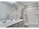 Bright bathroom featuring a double vanity and shower-tub combination at 1901 Toland Ct, Johns Island, SC 29455