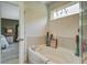 Clean and luxurious bathroom showcasing a large tub, decorative accents, and ample natural light at 1901 Toland Ct, Johns Island, SC 29455