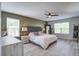 Calm bedroom with a gray headboard, soft bedding, ceiling fan, and neutral decor at 1901 Toland Ct, Johns Island, SC 29455