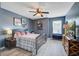 Well-lit bedroom with a ceiling fan, complemented by an accent wall and natural light at 1901 Toland Ct, Johns Island, SC 29455
