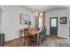 Cozy dining room offers a unique table, statement chandelier, and views to the backyard at 1901 Toland Ct, Johns Island, SC 29455