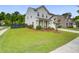 Well-manicured lawn surrounds this home with vinyl siding and a two-car garage at 1901 Toland Ct, Johns Island, SC 29455