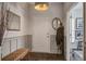 Stylish foyer with decorative mirror, bench and convenient coat rack at 1901 Toland Ct, Johns Island, SC 29455