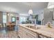 Open-concept kitchen with island seating flows into dining and living areas at 1901 Toland Ct, Johns Island, SC 29455