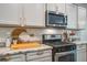 Modern kitchen features stainless steel appliances, marble counters, and neutral backsplash at 1901 Toland Ct, Johns Island, SC 29455